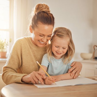 Mother helping her daughter practice handwriting