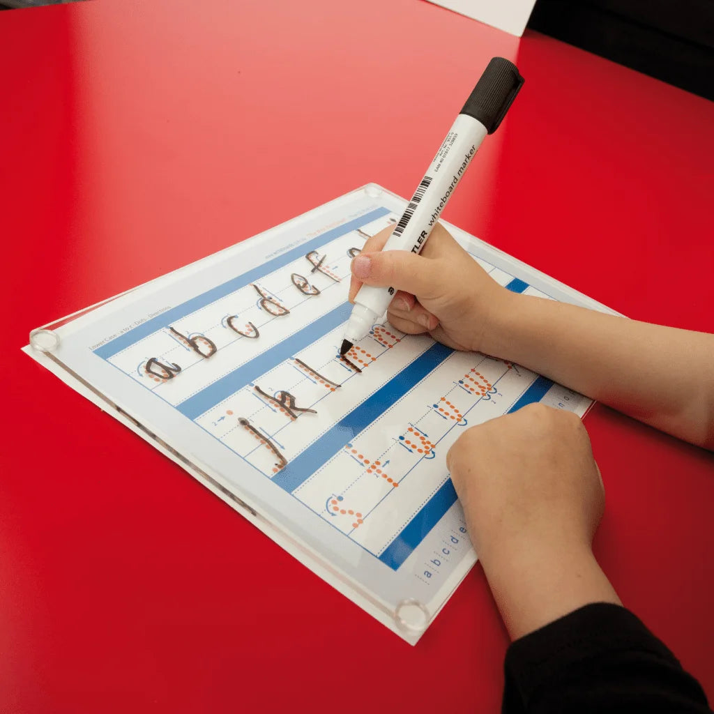 A child using a Writeboard to practice writing letters, showcasing its smooth, reusable surface